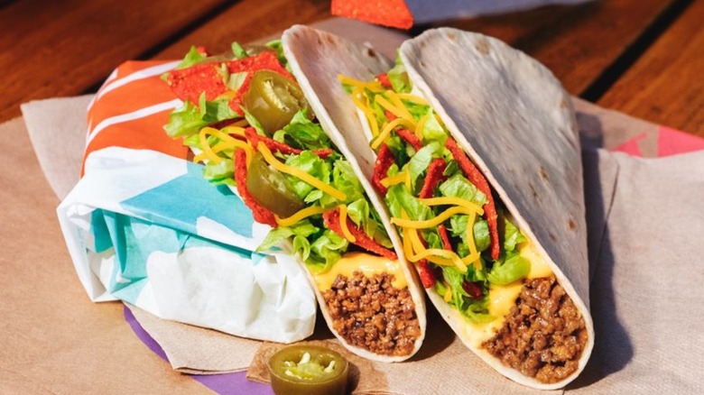 Soft tacos with ground beef, lettuce, cheese, red strips
