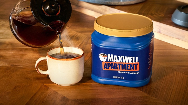 cup of coffee being poured next to Maxwell Apartment container