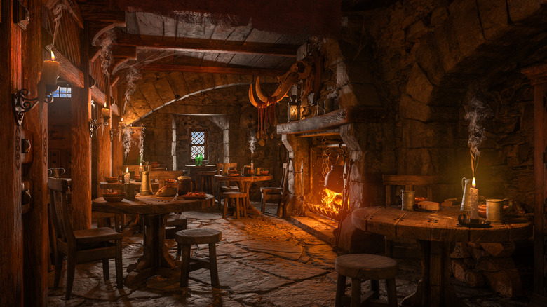 Dark, ancient pub or tavern lit by candlelight and fireplace