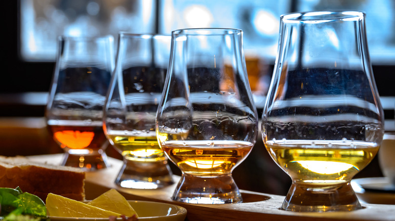 A flight of whiskeys with different colors and characteristics