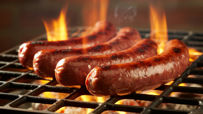 Grilling sausages over an open flame