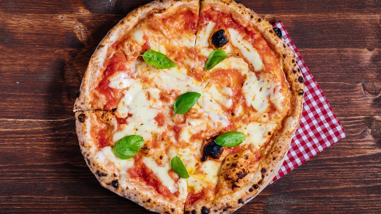 Margherita pizza on wooden table