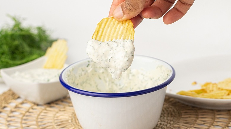 hand holding chip with dip