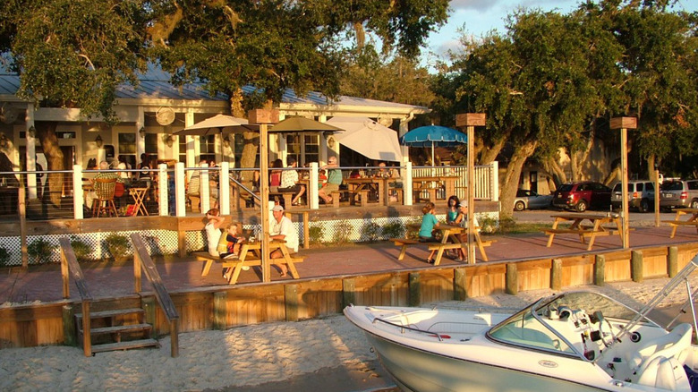 A photo of Aunt Kate's Restaurant in full sun taken from the water