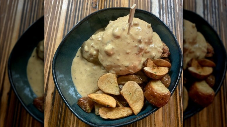 The dirty South biscuit with gravy and potatoes