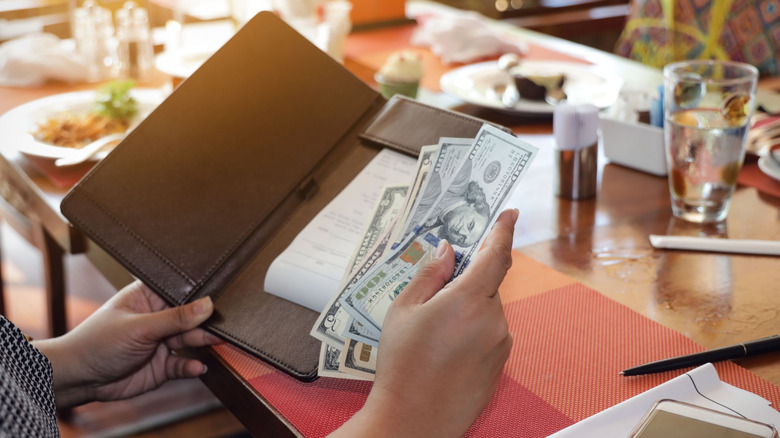 person paying bill in restaurant
