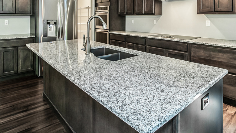Granite countertopsand chrome faucet in kitchen