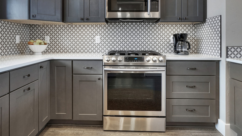 Gray kitchen with gas oven as the focal point