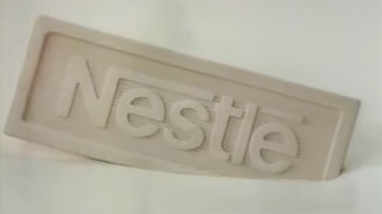 Close-up of a white chocolate bar with the Nestlé logo