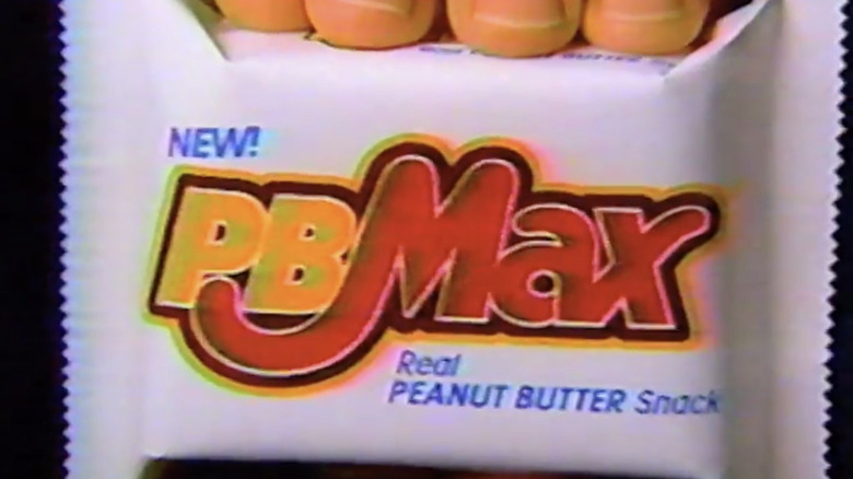Close-up of a vintage white PB Max candy bar wrapper with a bold logo in yellow and red