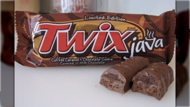 A Twix Java bar in two halves in front of its packaging