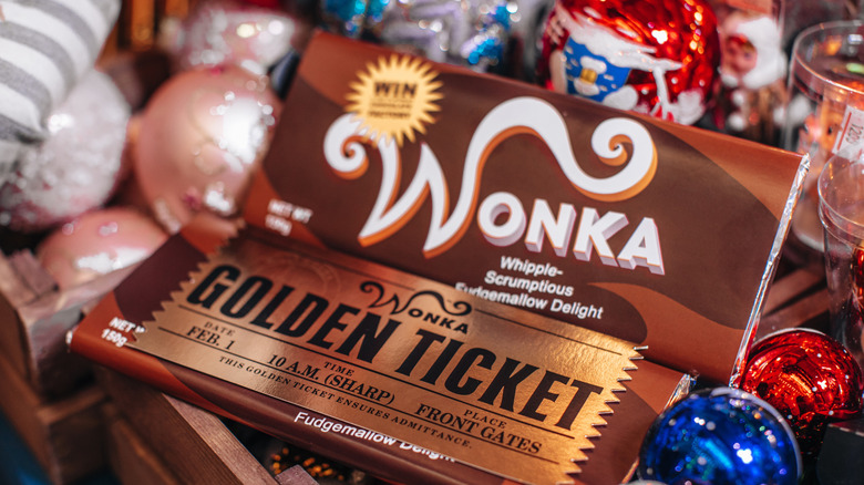 A Wonka Golden Ticket candy bar surrounded by colorful foil-wrapped chocolates