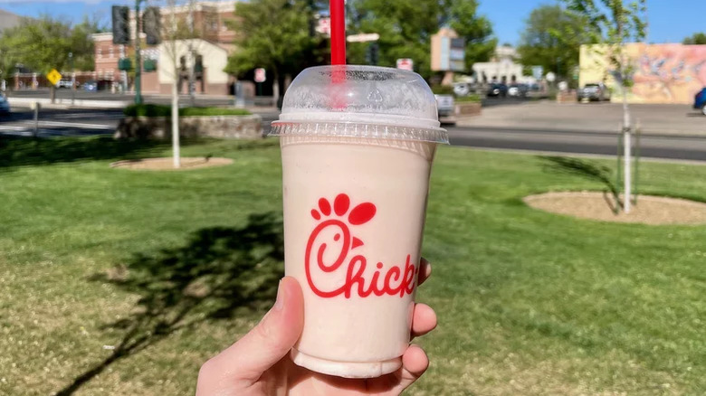 Holding a frosted cloudberry lemonade from Chick-fil-A