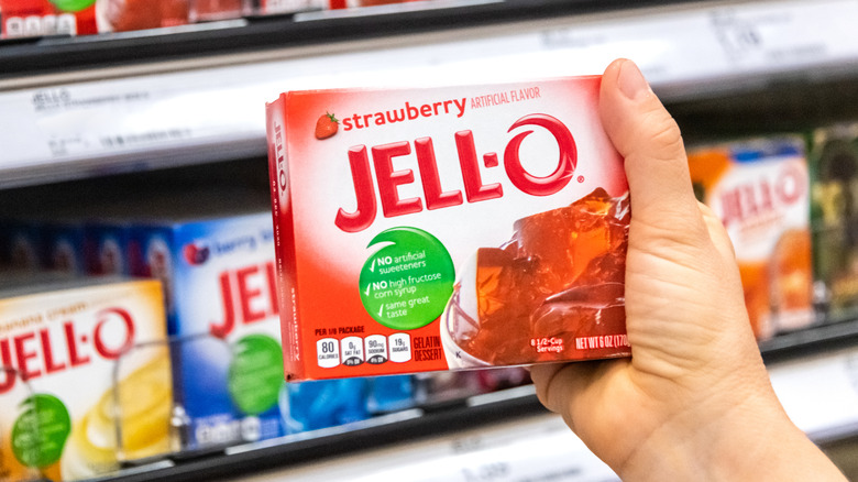 box of strawberry Jell-O in hand