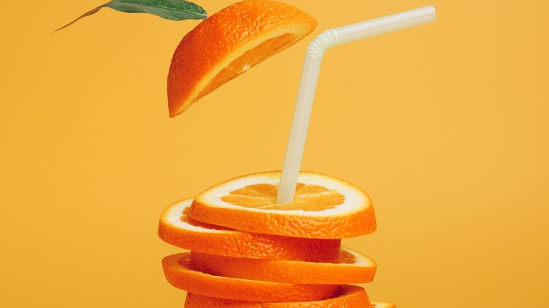 Stack of orange slices with straw