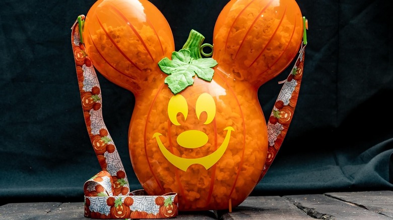 a mickey mouse shaped popcorn holder on a table