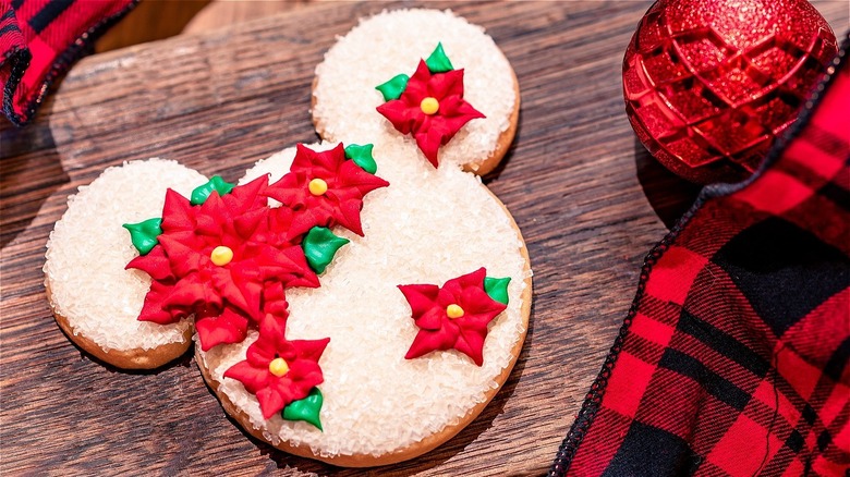 Mickey Mouse-shaped holiday cookie with icing poinsettia