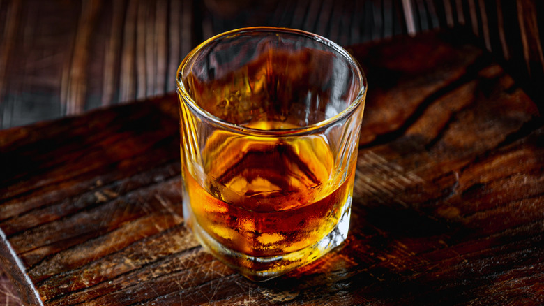 Glass of bourbon on a wooden table