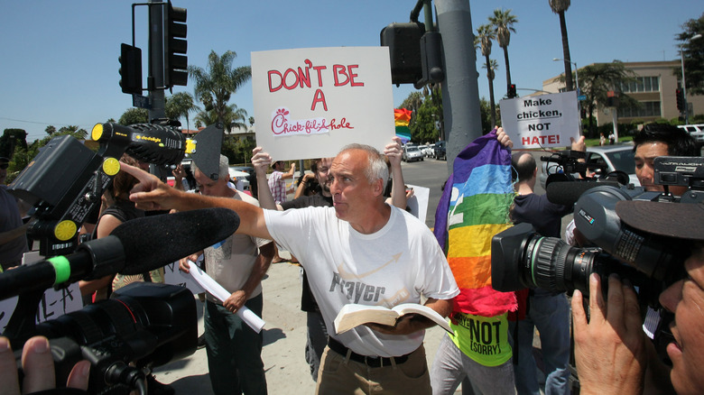 Man reading bible to Chick-Fil-A prostesters