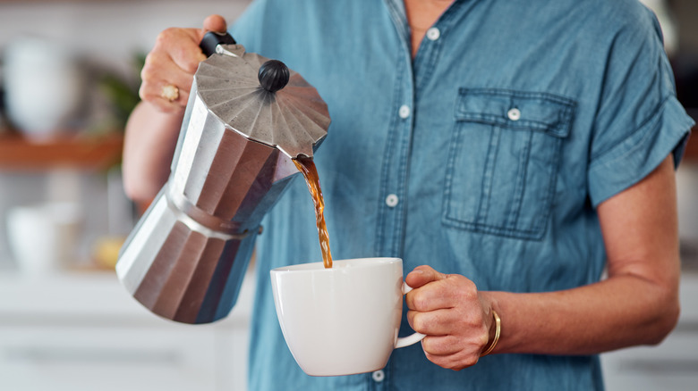 woman pouring coffee into cup