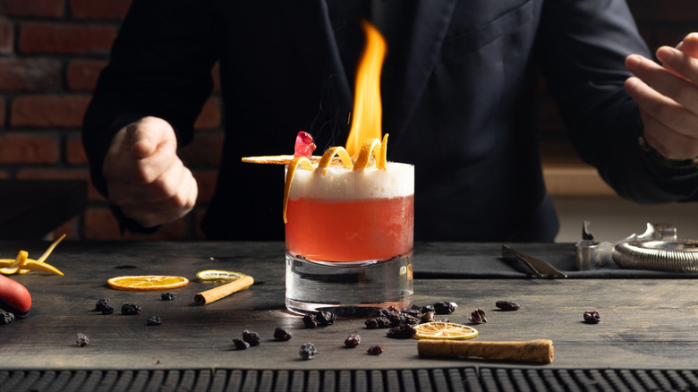 Bartender making a flaming cocktail