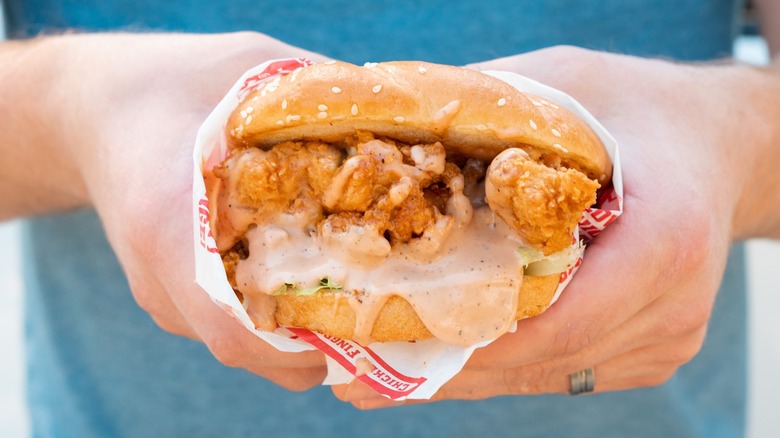 hands holding Raising Cane's sandwich