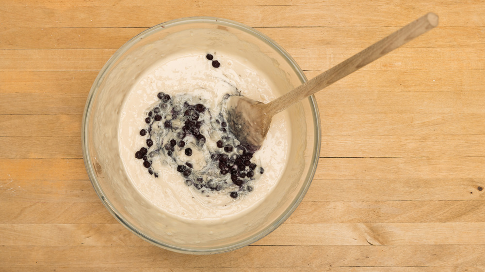 Mixing blueberries and batter bowl