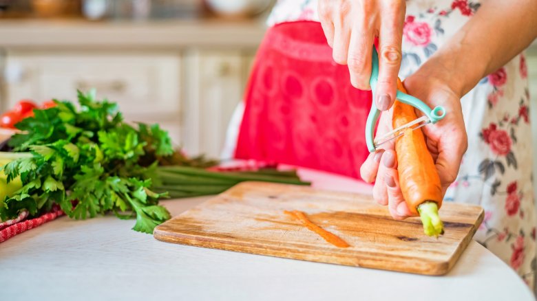 Woman peeling carrots