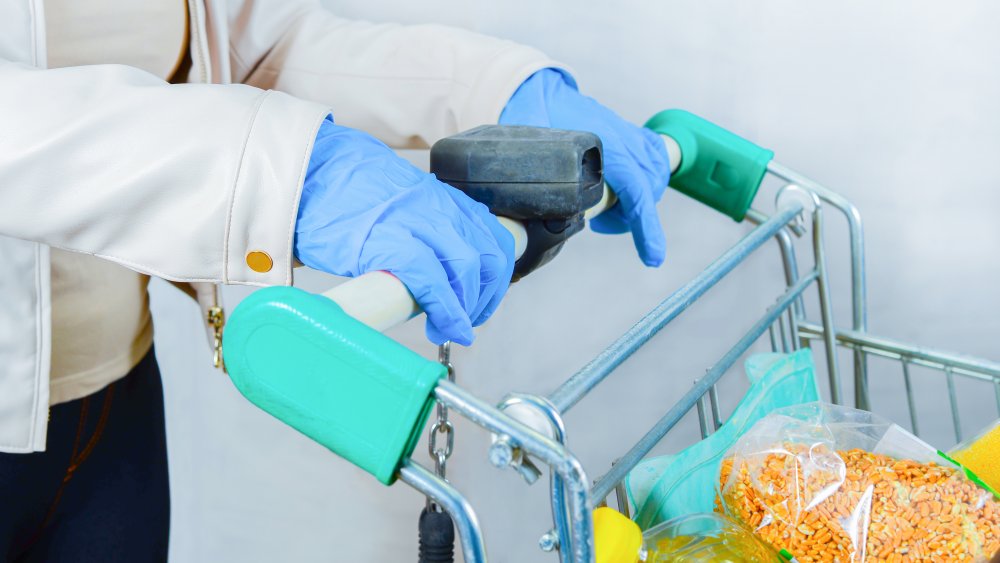 Grocery shopper wearing latex gloves