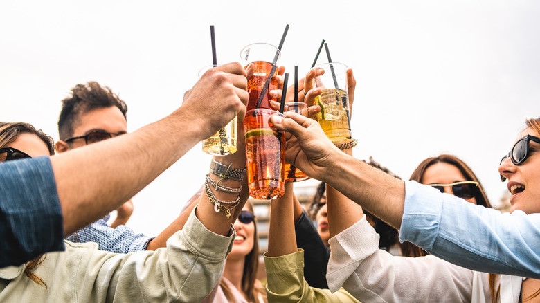 friends cheering with cocktails