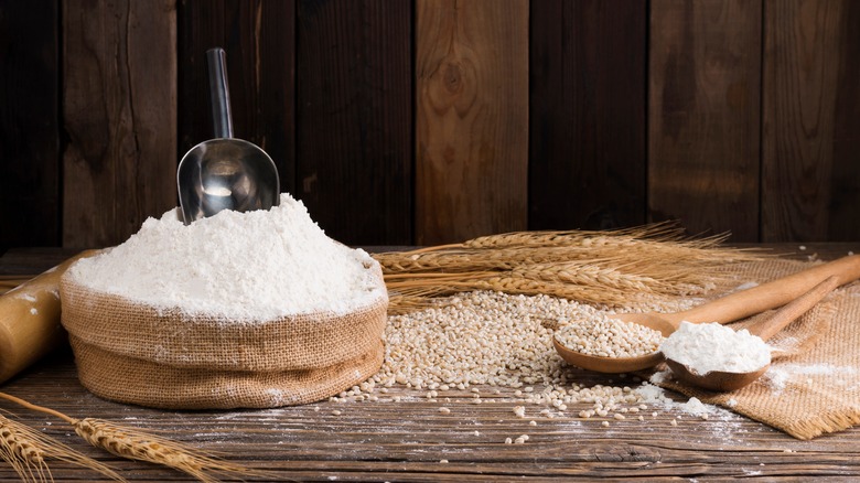 Grains and flour on wooden table