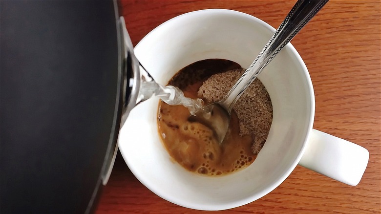water poured on to instant coffee grounds