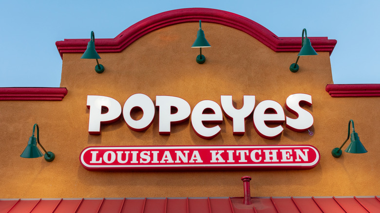 Sign on the front of a Popeyes shop