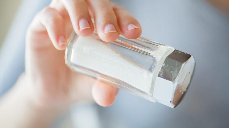 Hand pouring salt