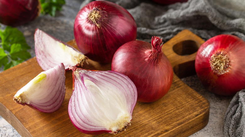 Purple onions on top of a cutting board