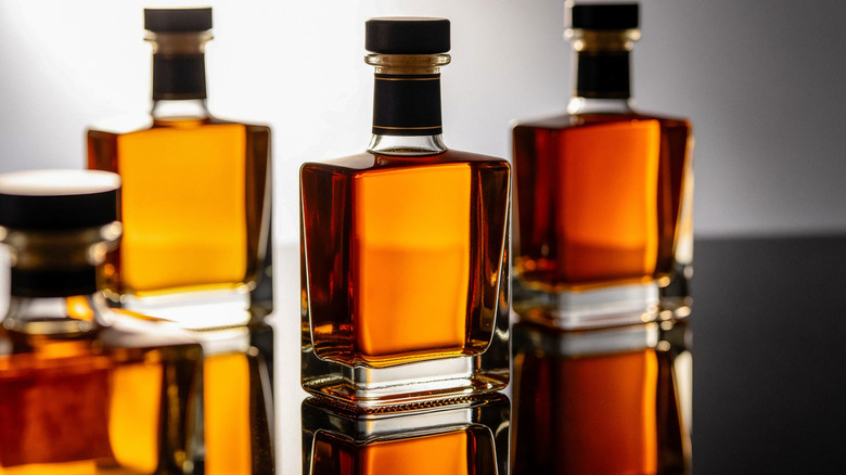 Brown liquor bottles against white background