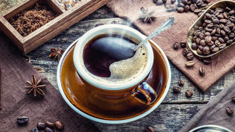  Steaming cup of coffee and beans