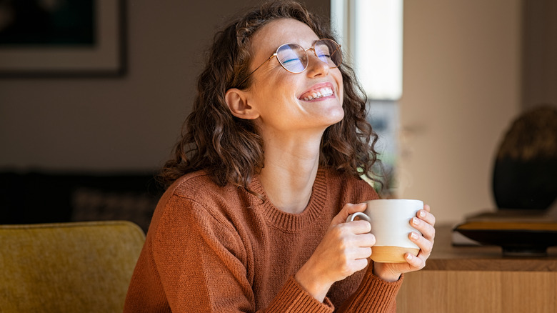 Lady enjoys cup of coffee