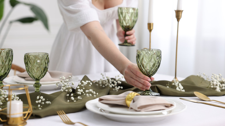 person setting table for dinner