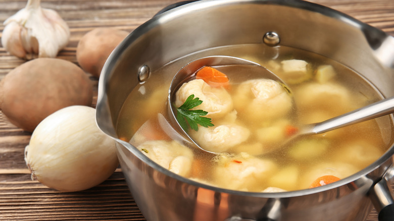 Ladle in pot of chicken and dumplings