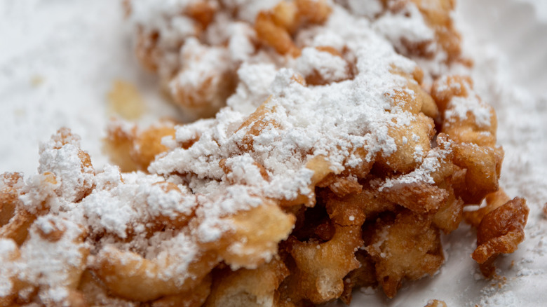 Closeup of funnel cake with powdered sugar