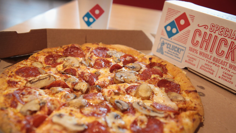 Domino's pizza with logo in the background