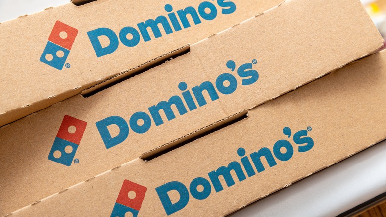 Three stacked Domino's pizza boxes
