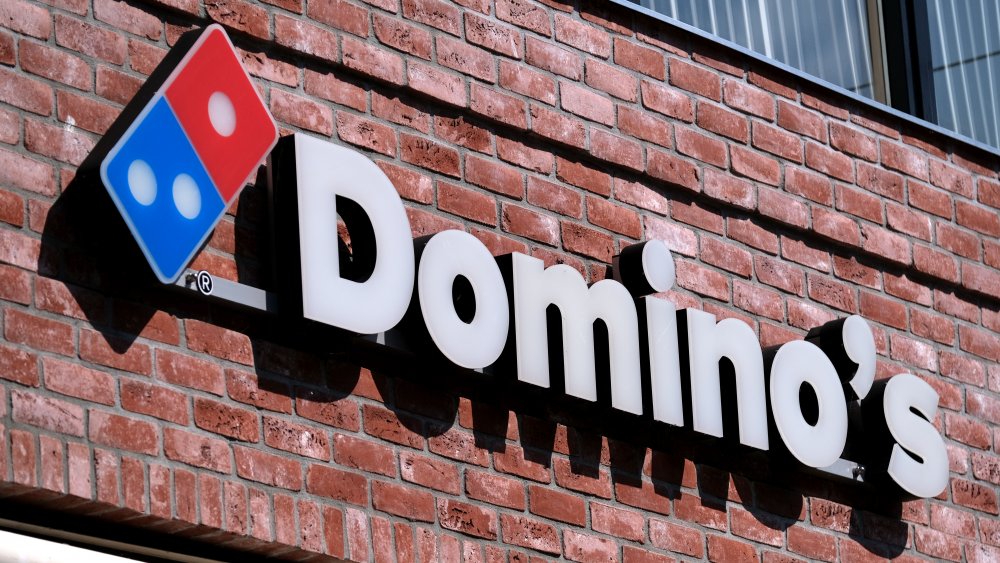 domino's pizza logo against a brick background