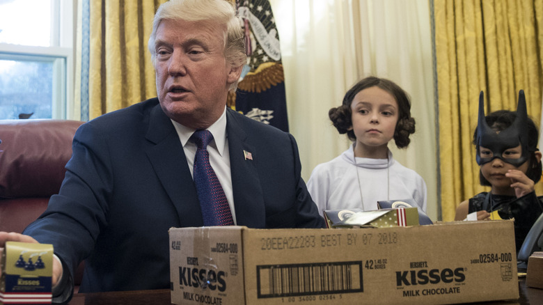 Donald Trump in the Oval Office with a box of Hershey's Kisses