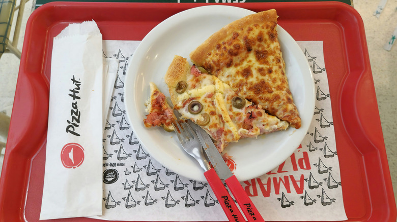 tray with pizza and cutlery from Pizza Hut
