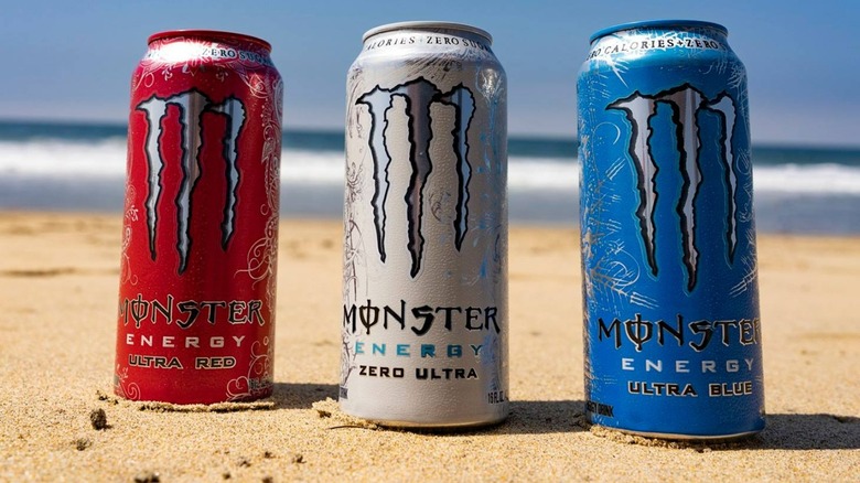 Monster Energy cans on beach