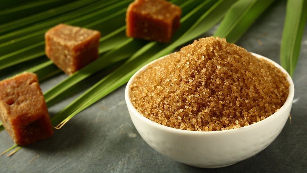 Bowl of brown sugar with cubes in background