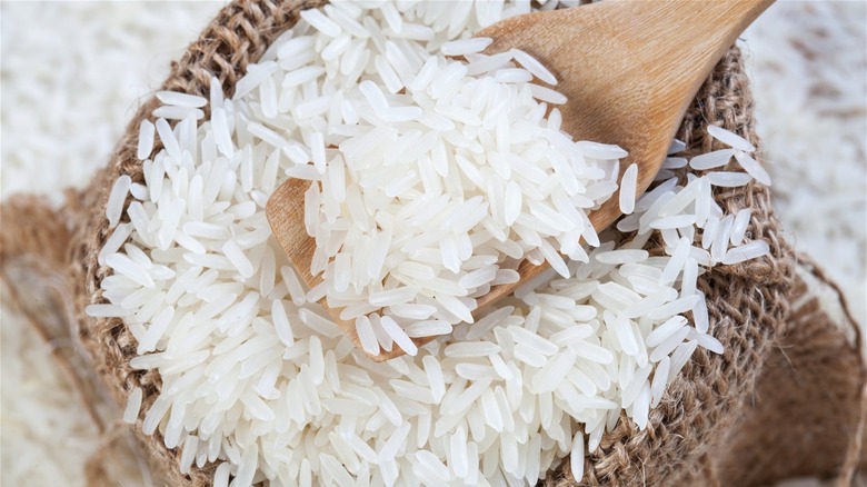 rice in a woven basket with wooden spoon