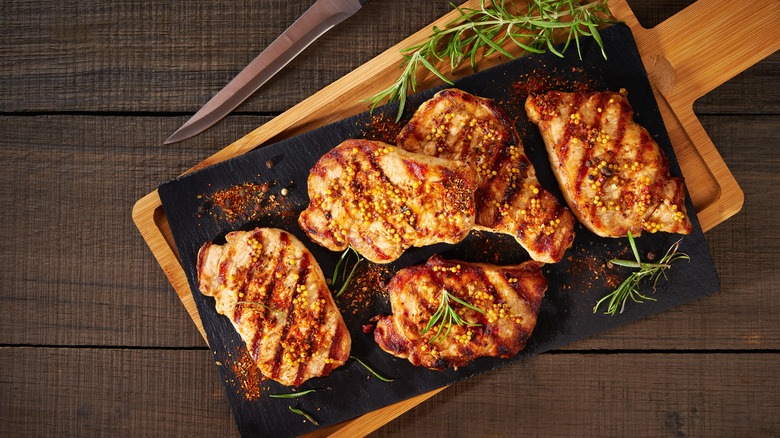 Grilled pork chops on board